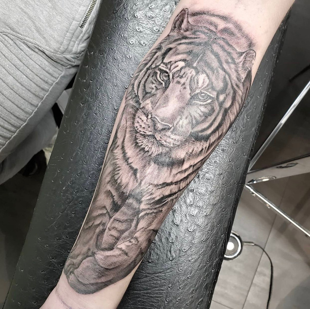 A black and grey realism tattoo photographed